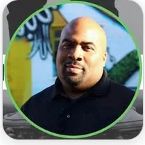Todd Davis in a black shirt, framed by a green ring.